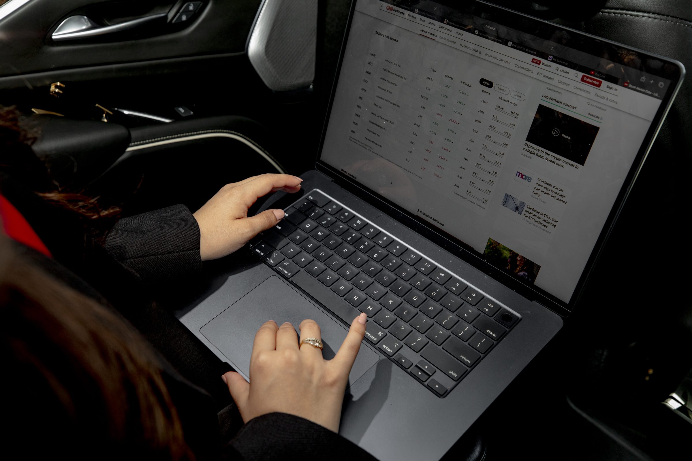 Passenger working on a laptop in a Nashlux back seat