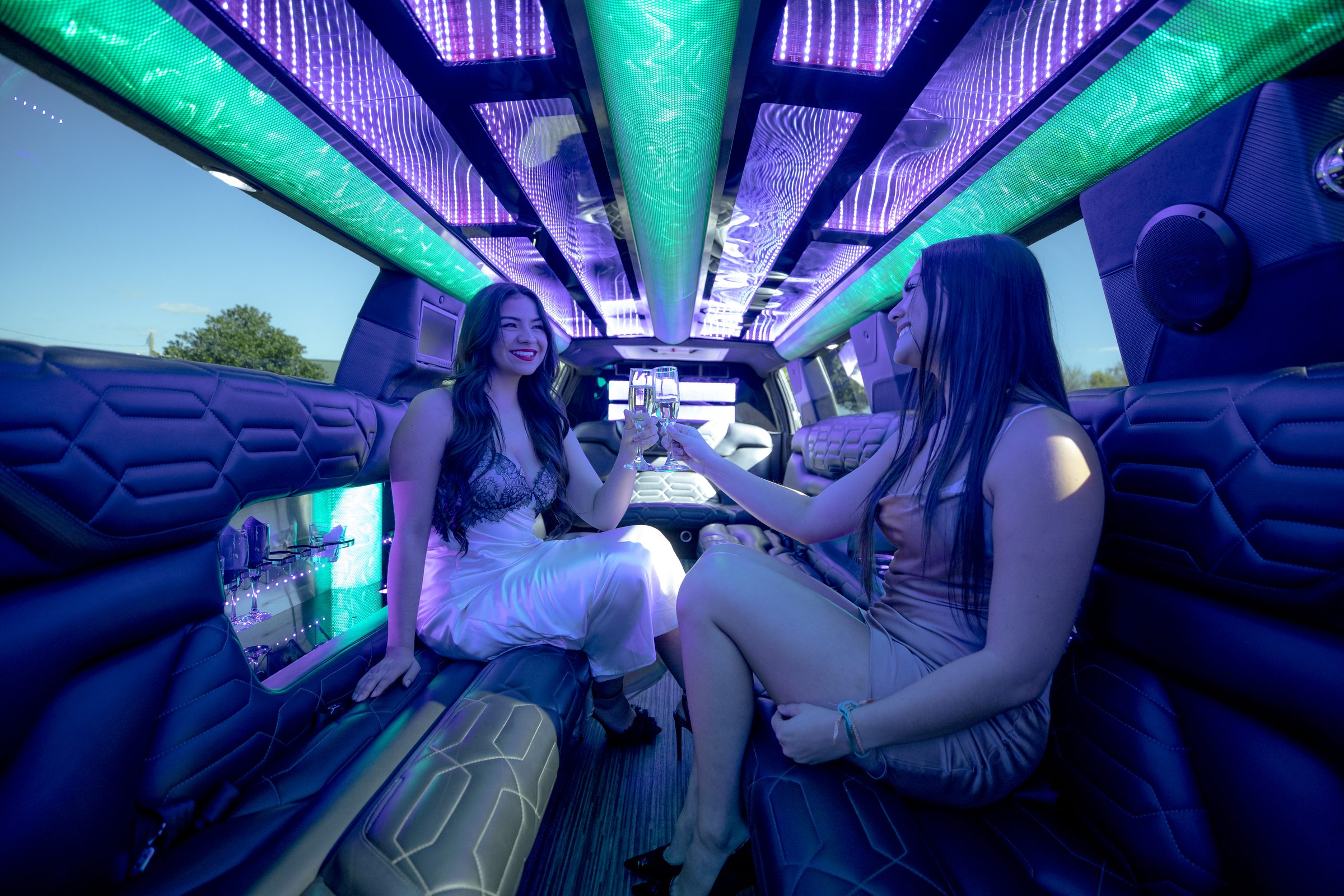 Guests toasting champagne inside a Nashlux limo