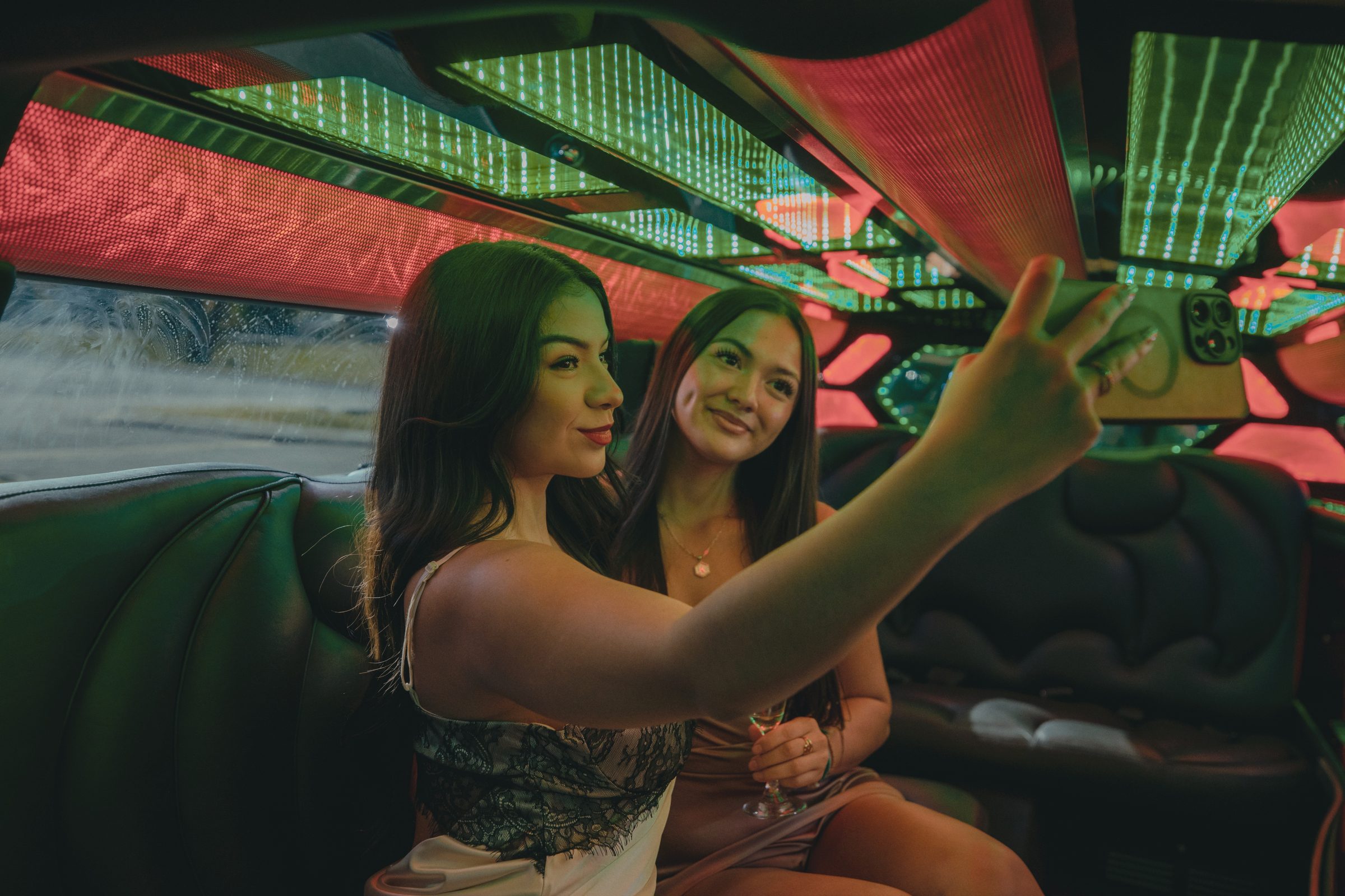 Guests toasting in a purple-lit limo